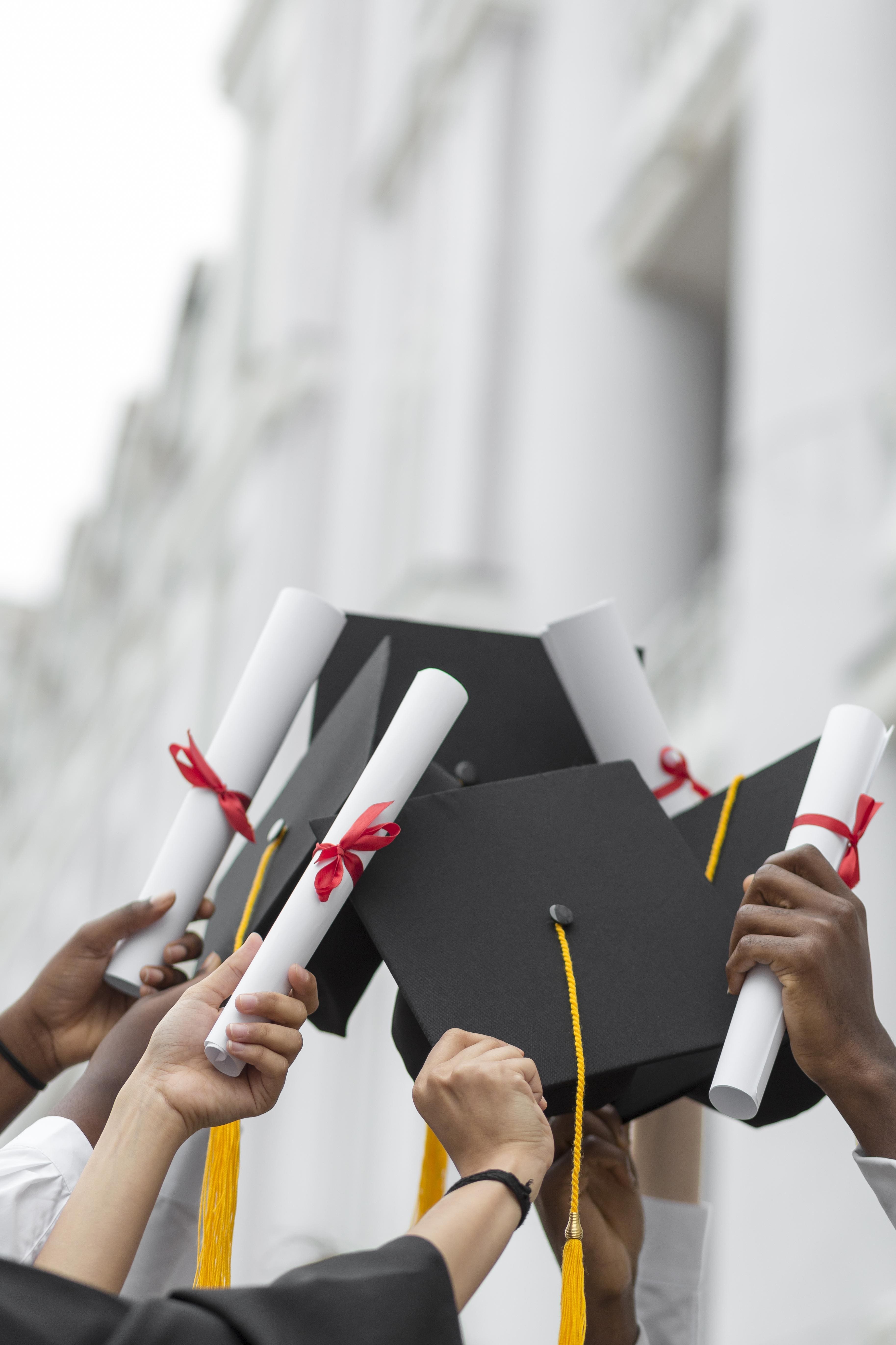 Students celebrating graduation with caps thrown in the air, representing successful study abroad journey